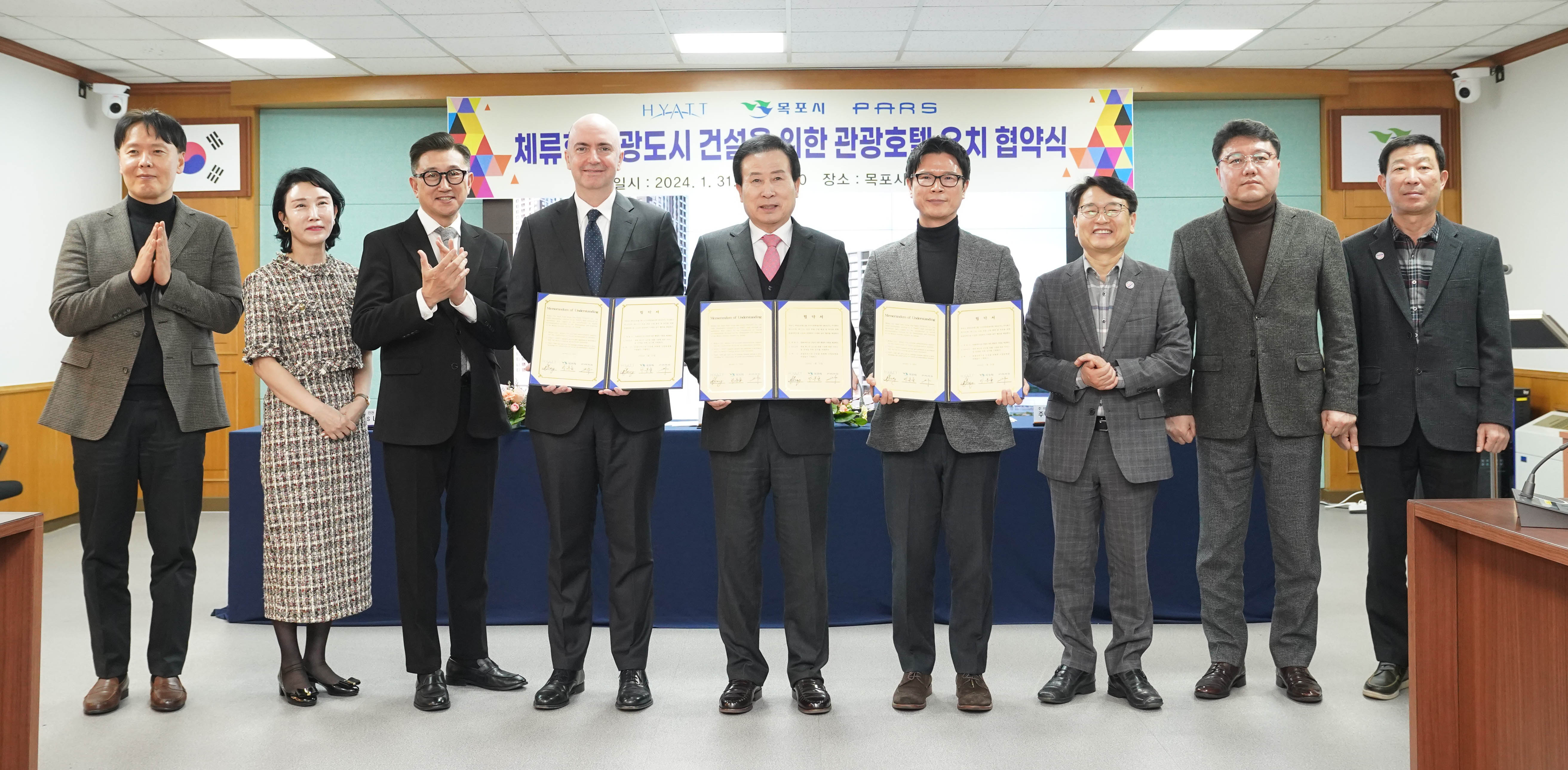 HYATT 목포시 PARS체류형 관광도시 건설을 위한 관광호텔 유치 협약식 일시 : 2024. 1. 31(수) 16:30 장소 : 목포상황실 현수막 아래에서 협약서를 들고 있는 박홍률 시장과 관계자들2