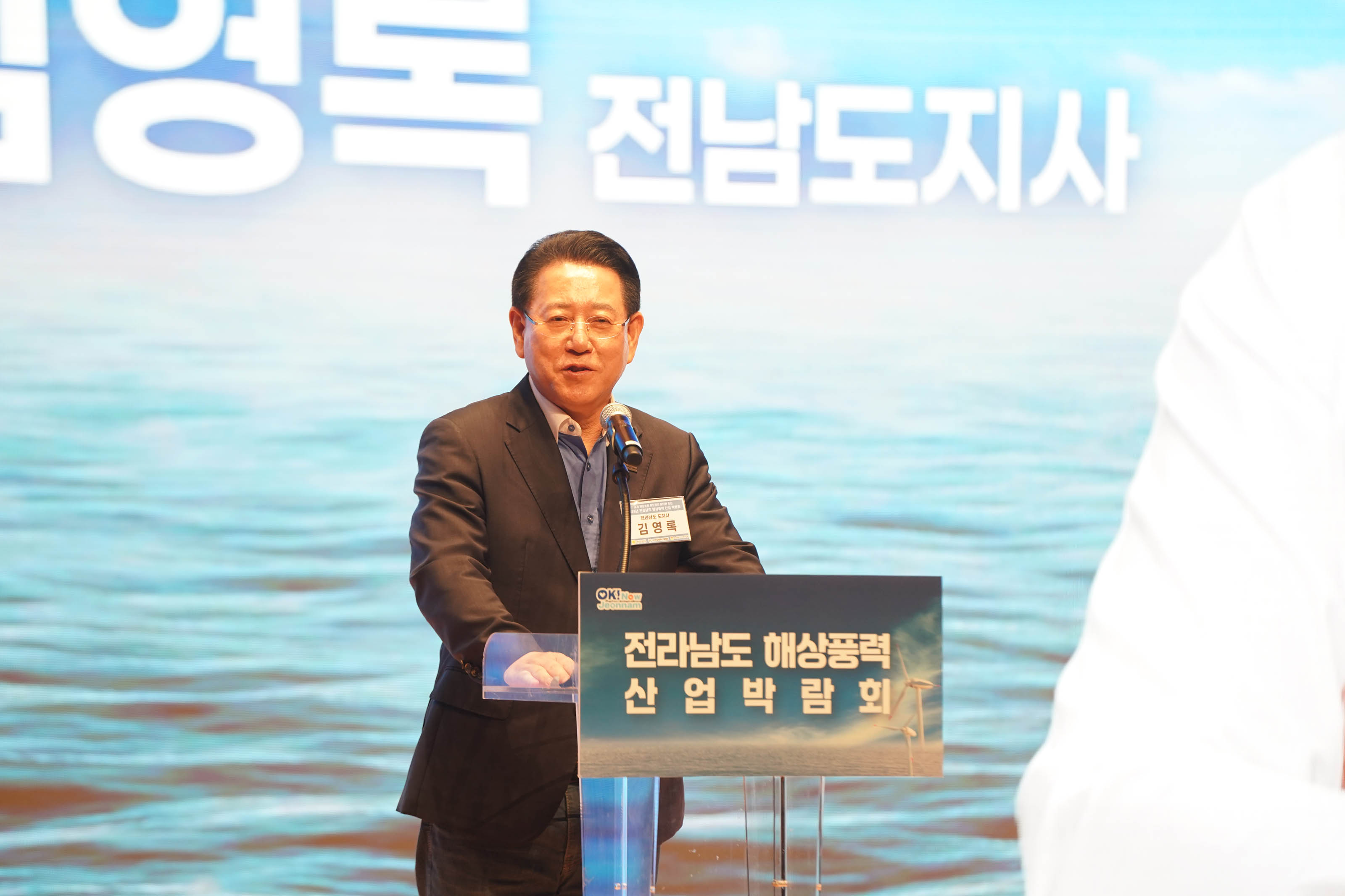 전라남도 해상풍력 산업 박람회 연단에서 개회사를 하고 있는 김영록 전남도지사의 모습. 배경에 '김영록 전남도지사' 텍스트가 보임.
